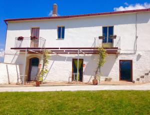 a white house with two balconies on it at Bed & Wine Rocco Zambri in Bovino