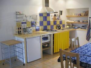 a small kitchen with a counter with a stove at Gîte Périssé, le petit Gîte in Libaros