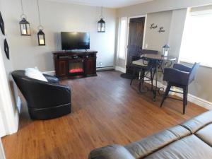 a living room with a couch and a table with a fireplace at Secret Cottage Yellowstone 1 bd 2 beds dtwn #1 in Cody