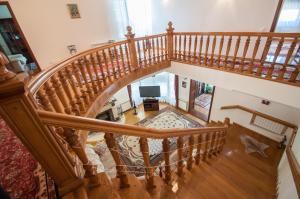 an overhead view of a wooden spiral staircase in a house at Magnificent Villa in Chişinău