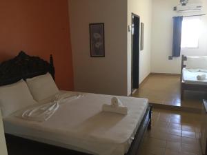 Postel nebo postele na pokoji v ubytování Beach Hotel Jacuma