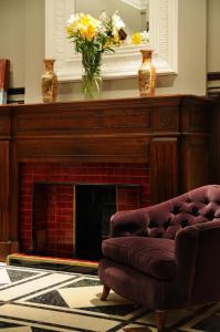 a fireplace with a couch and vases on top of it at Casa Umare in Buenos Aires