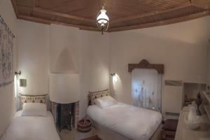 A bed or beds in a room at Urania Traditional Stone House