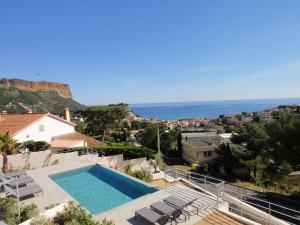 a villa with a swimming pool and a view of the ocean at Home Cassis - Maison Mediterranée - Piscine chauffée in Cassis