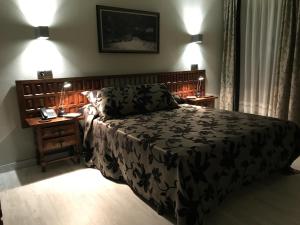 a bedroom with a large bed and two night stands at Hotel Casa Julián in Peñamellera Alta