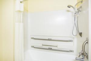 a bathroom with a shower curtain and a sink at Super 8 by Wyndham Kingman in Kingman +24 photos