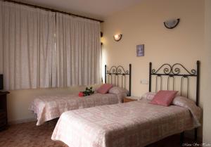 a bedroom with two beds and a window at Castillo del Mar in Almuñécar