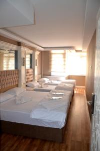 a room with four beds in a row at Sun Comfort Hotel in Istanbul +57 photos