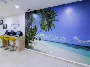an office with a wall mural of the beach at D' ART GALLERY HOTEL in Seri Iskandar