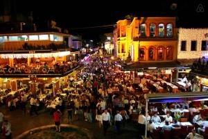 a crowd of people standing in a street at night at Sun Comfort Hotel in Istanbul