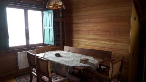 a dining room with a table and chairs and windows at Great Chalet Farellones in Farellones +31 photos