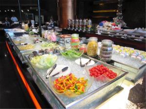 a buffet line with many different types of food at Jianguo Hotel in Beijing