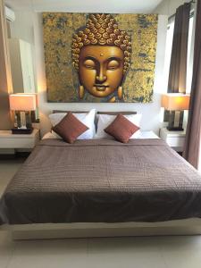 a bedroom with a bed with a large gold headboard at Umalas Apartment in Seminyak