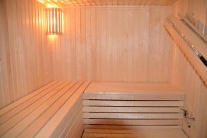 a sauna with a bench in a wooden tub at Medāji in Zaķumuiža +4 photos