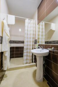 a bathroom with a sink and a shower at Hotel Galereya in Tomsk