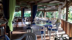 a dining room with a table and chairs on a deck at Casa de la Playa Beach Resort in Siquijor
