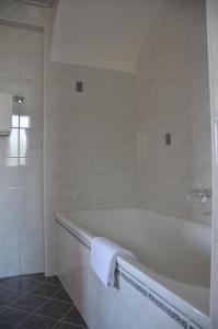 a bathroom with a bath tub with a towel on it at Hôtel Splendide in Crans-Montana