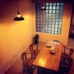 a wooden table and chairs in a room with a window at Lin's Inn in Ruisui