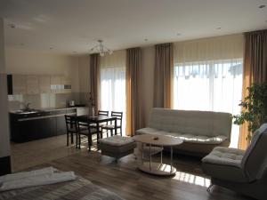 a living room with a couch and a table at Vila Laima in Šventoji