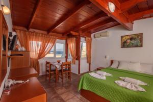 a bedroom with a bed and a table at Nikos Hotel in Matala