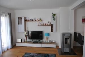 a living room with a flat screen tv on a table at Ferienwohnung Krause in Oberammergau