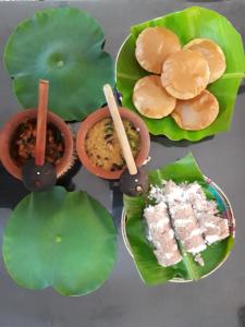 a group of plates of food sitting on leaves at Brinthavanam Days Inn in Jaffna