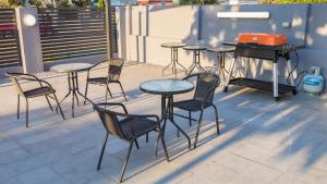 a table with chairs and a table cloth at Batavia Apartments in Perth