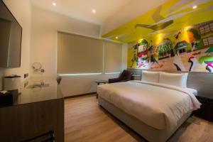 Postel nebo postele na pokoji v ubytování Legend Hotel Kaohsiung Pier2