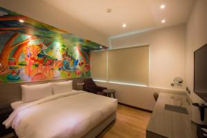 Postel nebo postele na pokoji v ubytování Legend Hotel Kaohsiung Pier2