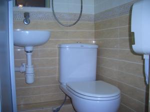a bathroom with a toilet and a sink at Sun Shine Guest House in Hong Kong