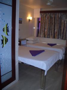 two beds in a small room with a window at Sun Shine Guest House in Hong Kong