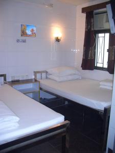 a room with two beds and a window at Sun Shine Guest House in Hong Kong +7 photos