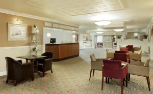 a lobby with a waiting room with chairs and tables at Coventry Hotel By Belvilla near City Centre in Coventry