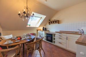 a kitchen with a table and a dining room at Ferienwohnung Ihr Zuhause am Meer in Thiessow