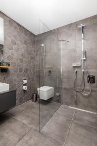 a bathroom with a shower and a toilet and a sink at SMARTments business Berlin City West in Berlin