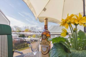 a bottle of wine sitting on a table with glasses at Ferienwohnung Ihr Zuhause am Meer in Thiessow