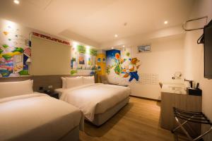Postel nebo postele na pokoji v ubytování Legend Hotel Kaohsiung Pier2