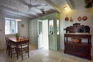 a kitchen with a table and a dining room at Roumanades Estate in Roumanádes