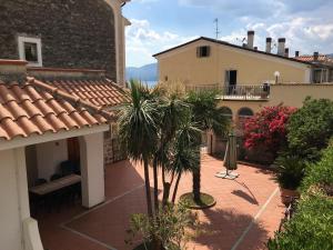 a courtyard with palm trees and a building at Case Vacanze Torre Petrosa in Villammare