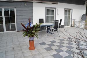 eine Terrasse mit einem Tisch und Stühlen auf einer Terrasse in der Unterkunft Erlebnispension Zum Wanderer Sepp in Arnbruck