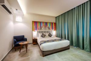 a bedroom with a large bed and a large window at The Belstead in Chennai