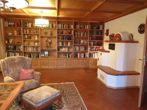 a living room filled with book shelves filled with books at Ferienhaus Lerche in Bad Birnbach