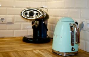 a juicer sitting on a kitchen counter with at Design apartment in Liepāja