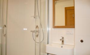 a bathroom with a sink and a shower at Design apartment in Liepāja +15 photos