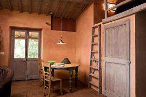 LubrianoにあるHoneymoon Cottageのテーブルとはしごとドアのある部屋