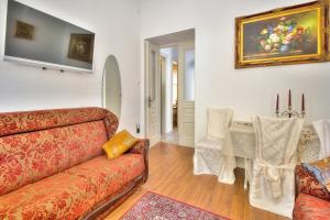 a living room with a couch and a table at Boutique Apartman Villa Mediteran in Poreč