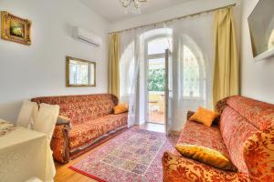 a living room with a couch and a window at Boutique Apartman Villa Mediteran in Poreč