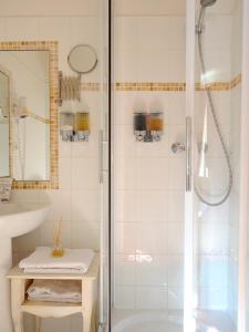 a bathroom with a shower and a sink at Hotel Spa Le Calendal in Arles