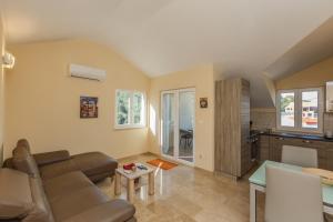 a living room with a couch and a table at Villa Joma 2 in Trogir