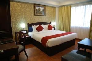 A bed or beds in a room at The Ruby Arena